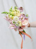 A Bridal/Wedding Bouquet in pastel colours, featuring Hyacinth, Lisianthus, Stock, Snapdragons and Scabiosa.