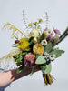 Image is of a native style wedding bouquet. Featured in the bouquet are Blushing Bride, Wattle, Mulla Mulla, Bankisa menziesii, Banksia praemorsa, Eucalyptus tetragona and Hypocalymma. 